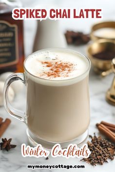 there is a cup of hot chocolate with cinnamon on the side and spices around it