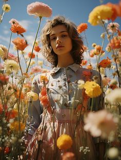 a woman standing in a field of flowers