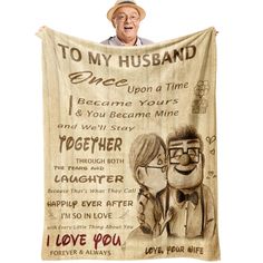 an old man is holding up a blanket with the words to his husband