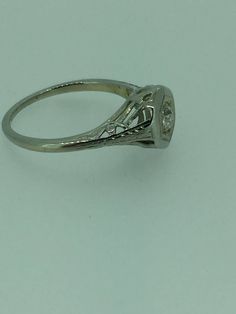 18kt White Gold Lady's Diamond Engagement/Anniversary Ring that is Vintage/Estate and Art Deco containing 1- .20ct total weight Old Miners European Cut Diamond SI1 clarity, GH color set in a hexagon scroll beads head and mounting. This style of ring is hard to find in this very good condition. The ring is a size 6 1/2. This item would Retail for $1,330.00 Diamond Bezel Setting Fine Jewelry For Wedding, Diamond Bezel Setting Fine Jewelry, Fine Jewelry Diamond Ring With Bezel Setting For Wedding, Collectible Platinum Diamond Ring In Diamond White, Collectible Diamond White Platinum Diamond Ring, Platinum Collectible Diamond Ring, Art Deco Brilliant Cut Diamond Ring Collectible, Collectible 14k Gold Diamond Ring, Platinum Diamond Ring With Diamond Cut For Collectibles