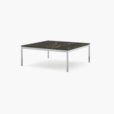 a table with a black marble top and metal legs, on a white background in the style of minimalism