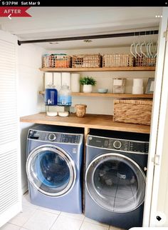 a washer and dryer in a small room with open shelving on the wall