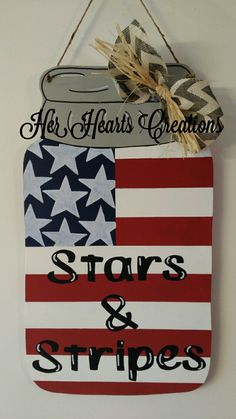 an american flag hanging on the wall with stars and stripes painted on it, next to a sign that says he hearts creations