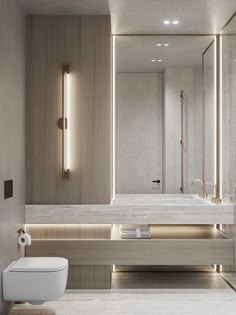 a bathroom with a toilet, sink and large mirror in the wall next to it