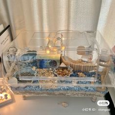 a display case filled with lots of different types of food and candles on top of a table