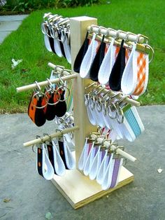 a rack with several pairs of shoes hanging from it's hooks on a sidewalk