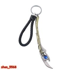 a metal key chain with a blue stone in the center and an arrow shaped blade attached to it