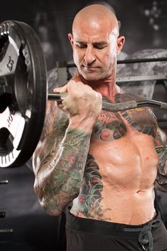 a man holding a barbell in front of his chest