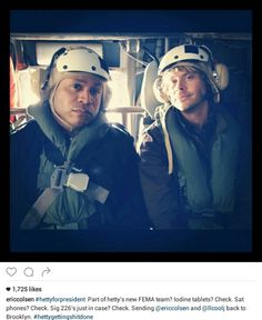 two men wearing helmets sitting next to each other