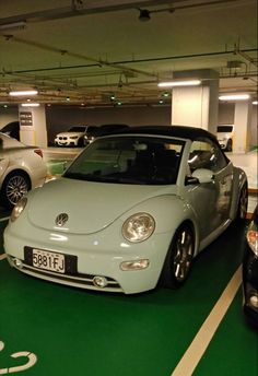 two cars are parked in a parking garage