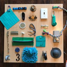 various items are laid out on a wooden table with scissors, keys and other accessories