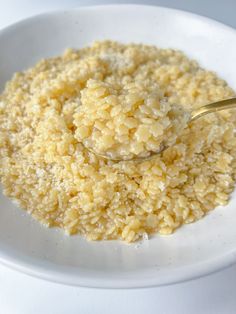 a white bowl filled with rice on top of a table