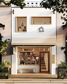 a coffee shop with two people sitting in the window