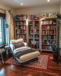 a living room filled with lots of books and furniture