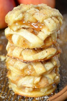 a stack of apple pies sitting on top of a table