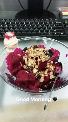 a glass bowl filled with food next to a keyboard