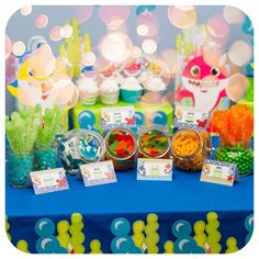 a table topped with lots of candy and cupcakes