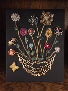 a bunch of brooches sitting on top of a wooden table