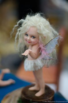 a small white fairy figurine sitting on top of a table