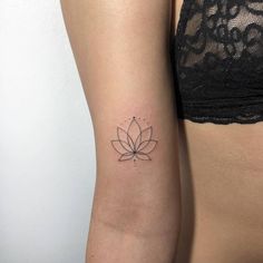 a woman's lower arm with a lotus tattoo on the left side of her right arm