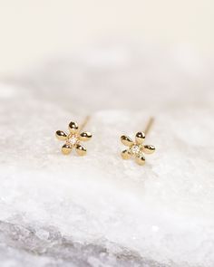 This exquisite 14k gold stud earring features a delicate flower design and a sparkling diamond stone. Its versatility allows for effortless pairing with any stud earrings in your collection. You can even wear it in the shower or while swimming, making it perfect for everyday wear. 5mm Flower Stud Earring with Diamonds Available in 14k Yellow Gold, White gold and Rose Gold. 1 Pair / 14k solid gold posts and backings Dainty 14k Gold Flower Earrings, Gold Earrings Studs Simple, Gold Earrings For Kids, Simple Gold Earrings, Latest Bracelets, Fancy Jewelry Necklace, Fancy Jewellery Designs, Cvd Diamond, Gold Rings Fashion