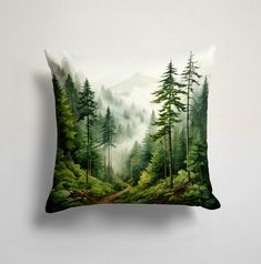 a pillow with a forest scene on it