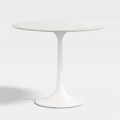 a white table sitting on top of a white floor