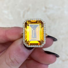 A lively emerald cut natural citrine cocktail ring, featuring an 11.35 carat deep orange citrine set in 18k yellow gold double prongs. Surrounding the gemstone is a beautiful halo of round brilliant cut diamonds. Accenting the stone is a leaf motif openwork under-gallery, completely hand-crafted in 18k yellow gold.
The measurements of the ring including the halo are approximately 16.07mm x 13.05mm.
This ring can be resized to any finger size at no additional cost.
If you have any questions regarding the Biscayne ring, please feel free to contact us. Estate Diamond Jewelry, Orange Citrine, Deep Orange, Leaf Motif, Citrine Stone, Natural Citrine, 10th Anniversary, Perfect Engagement Ring, Unique Engagement Rings