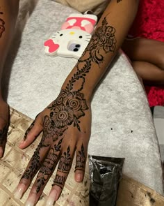 a woman with henna tattoos on her hands