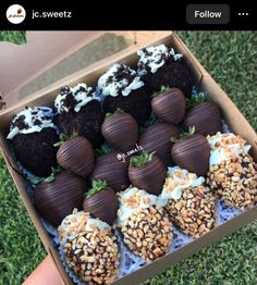 chocolate covered strawberries are in a box on the grass