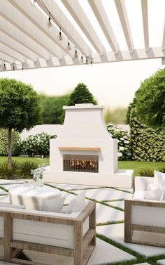 an outdoor living area with white furniture and a fireplace