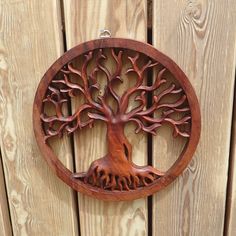 a wooden wall hanging with a tree on it