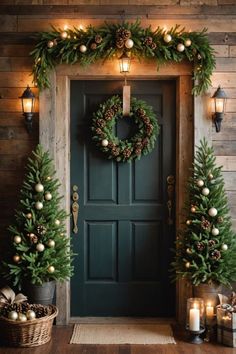 a green door decorated with christmas wreaths and pine cones, lit by candles on either side