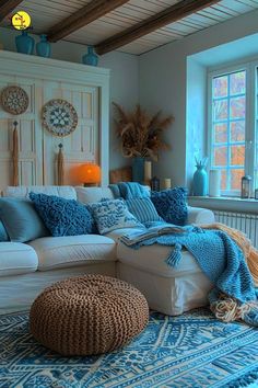 a living room filled with lots of furniture and pillows on top of a blue rug