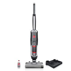 a vacuum is shown with its contents on the floor and in front of it are two cleaning products