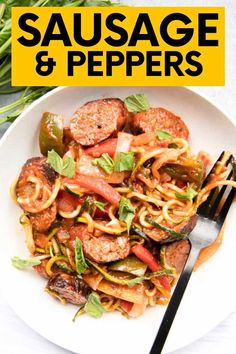 sausage and peppers with noodles in a white bowl on top of a table next to a fork