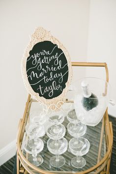 there is a sign that says you're getting married today next to many wine glasses