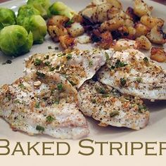 baked striper with potatoes and brussel sprouts on a white plate