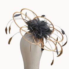 This is a looped fascinator hat with a central adornment of feathers which are set in smaller loops in the same colour satin as the feathers.  this version of this style also has a set of long feathers in the same colour as the satins so in the example of the photo we have long feathers in gold and shorter feathers in pewter to match the pewter satin loops in the centre. If you need more feathers i can add for an extra cost.  To choose a different colour combo just choose from the drop-down boxes. This item will be set on a 2cm wide headband which will be covered in the same satin as your base loops.  As you can see in the photos i also add an elastic millinery band that fits at the back of the neck and under the hair, for extra security.  I cannot place on a comb or covered headband. This Ostrich Feather Fascinator For Royal Ascot Races, Evening Feather Hat Headpiece, Evening Feathered Hat Headpiece, Evening Hat With Feathers, Royal Ascot Ostrich Feather Fascinator, Ostrich Feather Fascinator For Races, Royal Ascot Feather Trim Hat, Adjustable Feathered Top Hat For Evening, Adjustable Evening Top Hat With Feathers