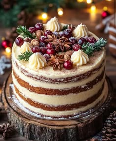 a christmas cake decorated with pine cones, cinnamons and cranberries on a wooden table