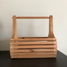 a wooden basket sitting on top of a table