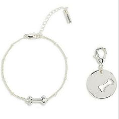 a bracelet with a dog bone charm on it and a key chain attached to it