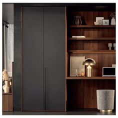 an open bookcase with wooden shelves in the background and a vase on the floor next to it