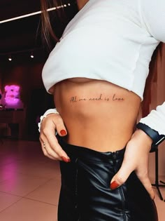 a woman is showing off her stomach with the words, all we need is love