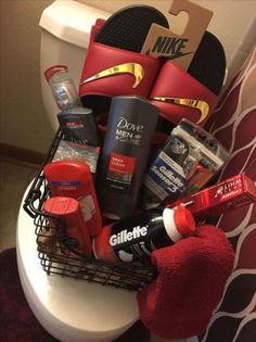 a basket filled with personal care items sitting on top of a white toilet next to a red towel