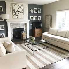 a living room filled with furniture and a fire place in the middle of a room