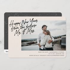 the save the date card is shown with an image of a man and woman hugging each other