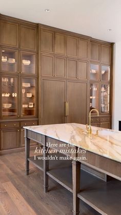 a large kitchen with marble counter tops and wooden cabinets