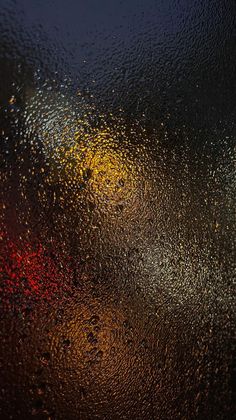 rain drops on the glass with red and yellow lights