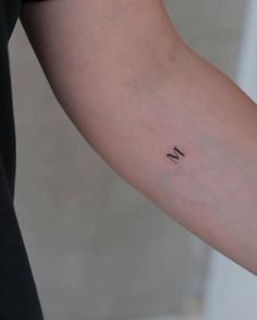 a person with a small tattoo on their arm